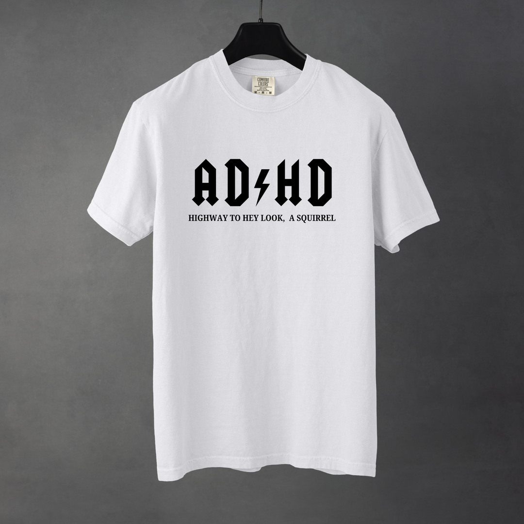 Sarcastic funny white graphic t-shirt with bold text saying 'ADHD highway to hey look a squirrel'