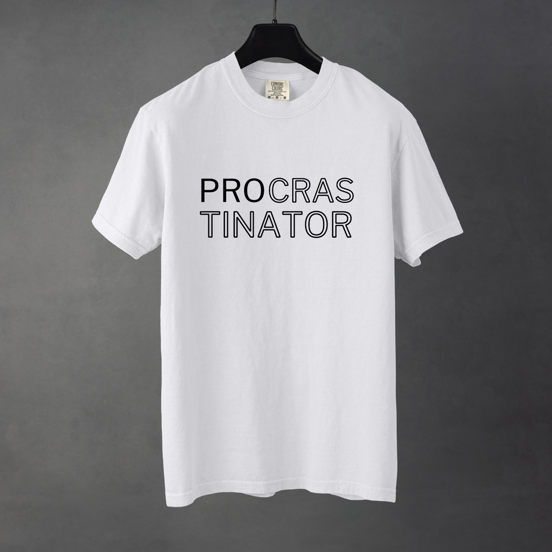 Sarcastic funny white graphic t-shirt with bold text saying 'Procrstinator'