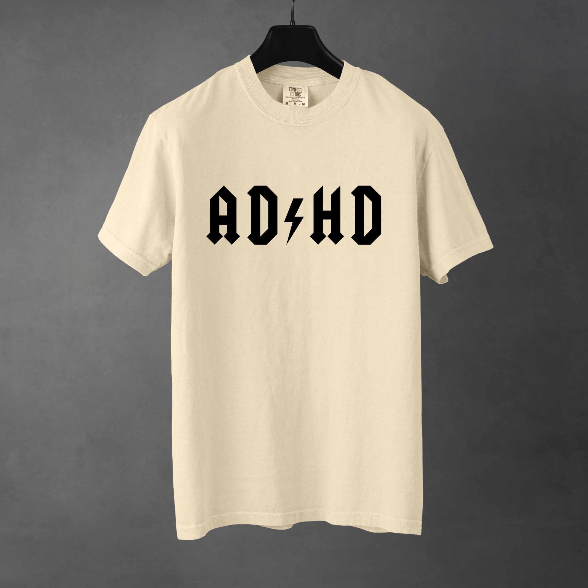 Sarcastic funny ivory graphic t-shirt with bold text saying 'ADHD'