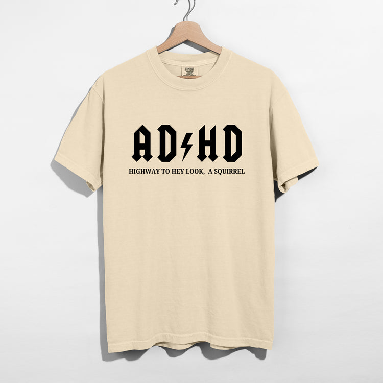 Sarcastic funny ivory graphic t-shirt with bold text saying 'ADHD highway to hey look a squirrel'