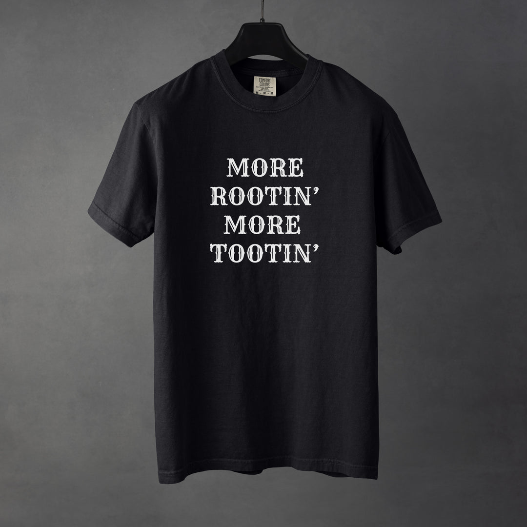 Sarcastic funny black graphic t-shirt with bold text saying more rootin' more tootin'