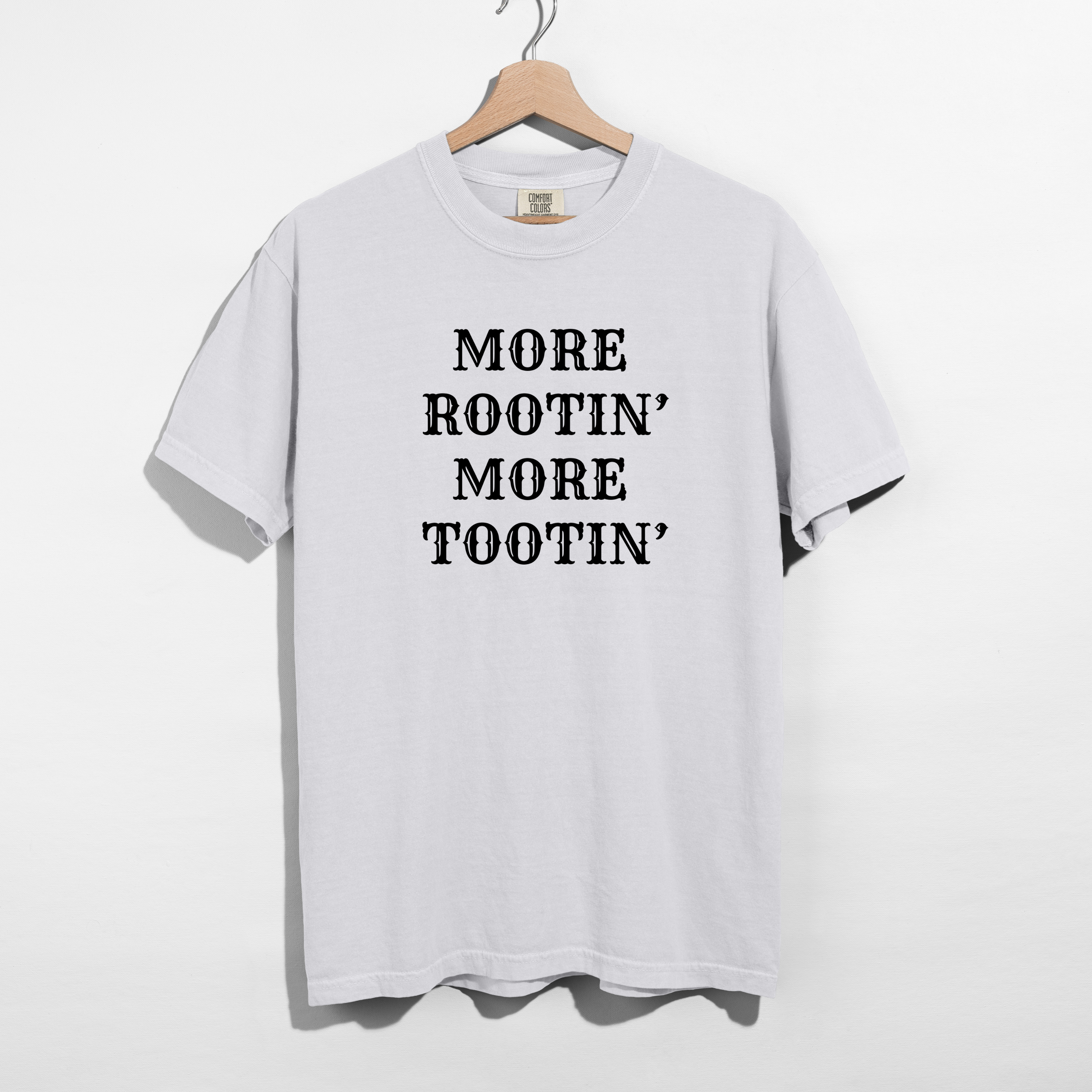 Sarcastic funny white graphic t-shirt with bold text saying more rootin' more tootin'