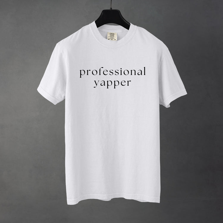 Sarcastic funny white graphic t-shirt with bold text saying 'professional yapper'